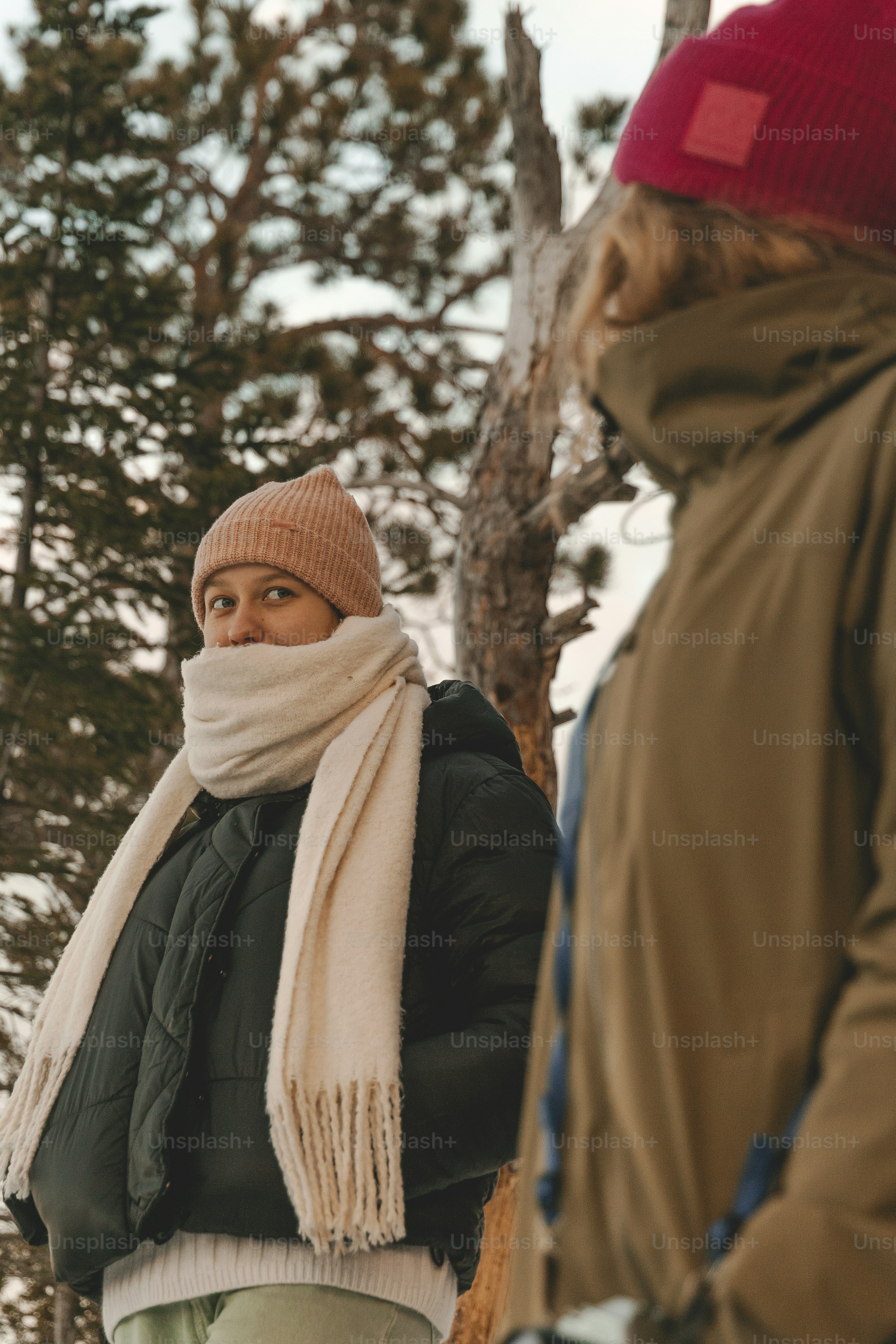 a man standing next to another man in the snow