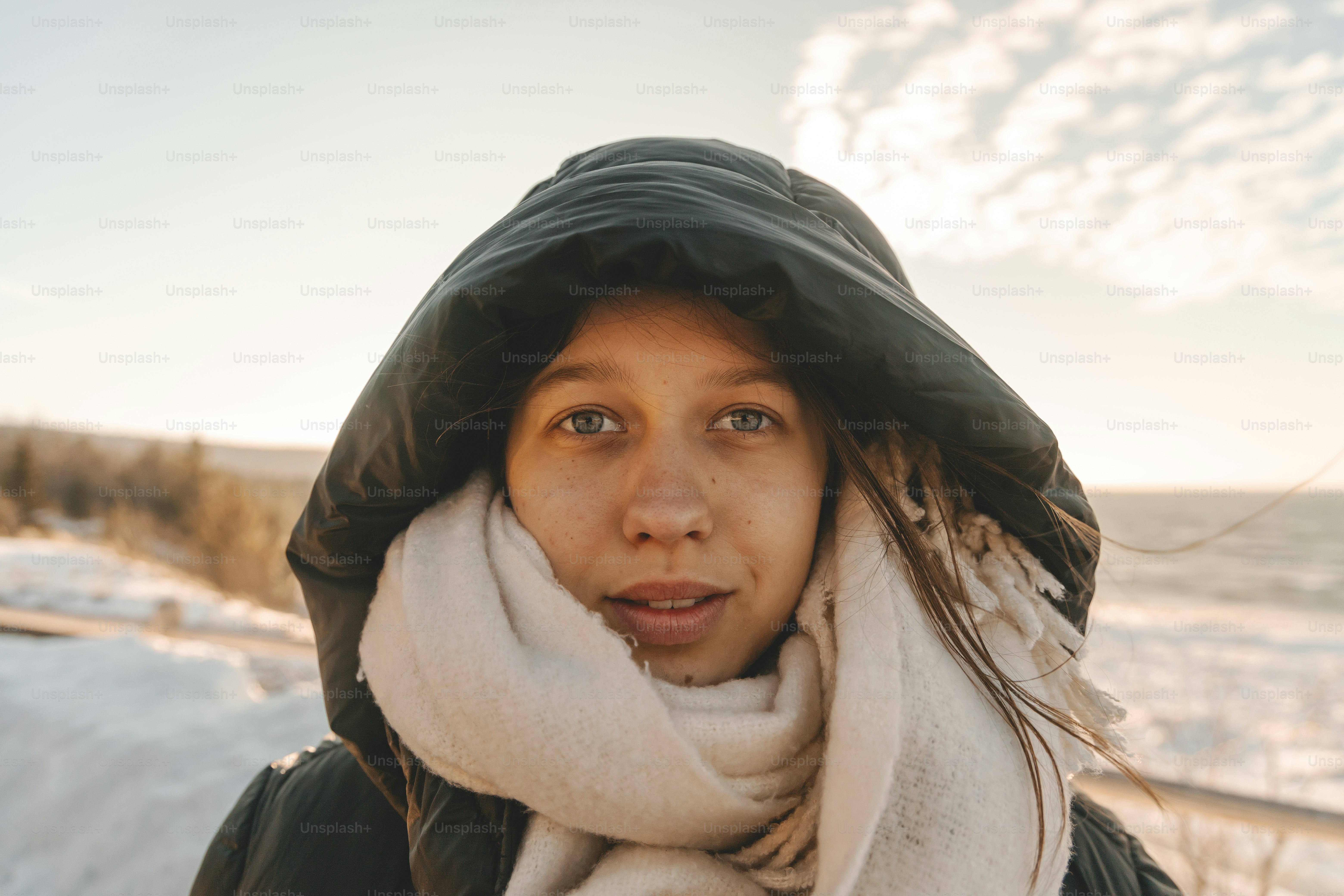a woman wearing a black jacket and a white scarf