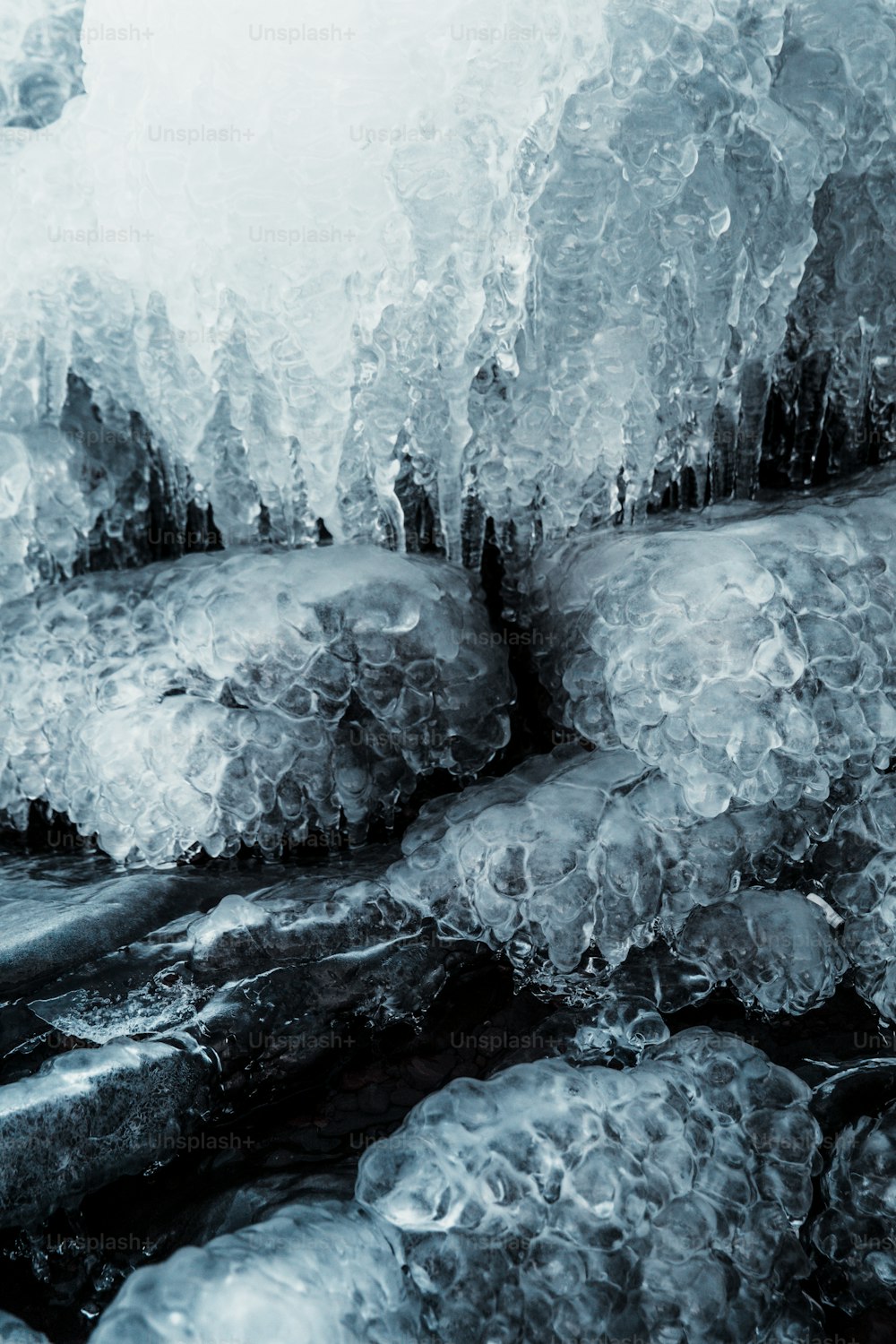 a black and white photo of ice and water