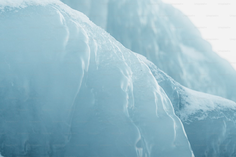 a snowboarder is going down a snowy mountain