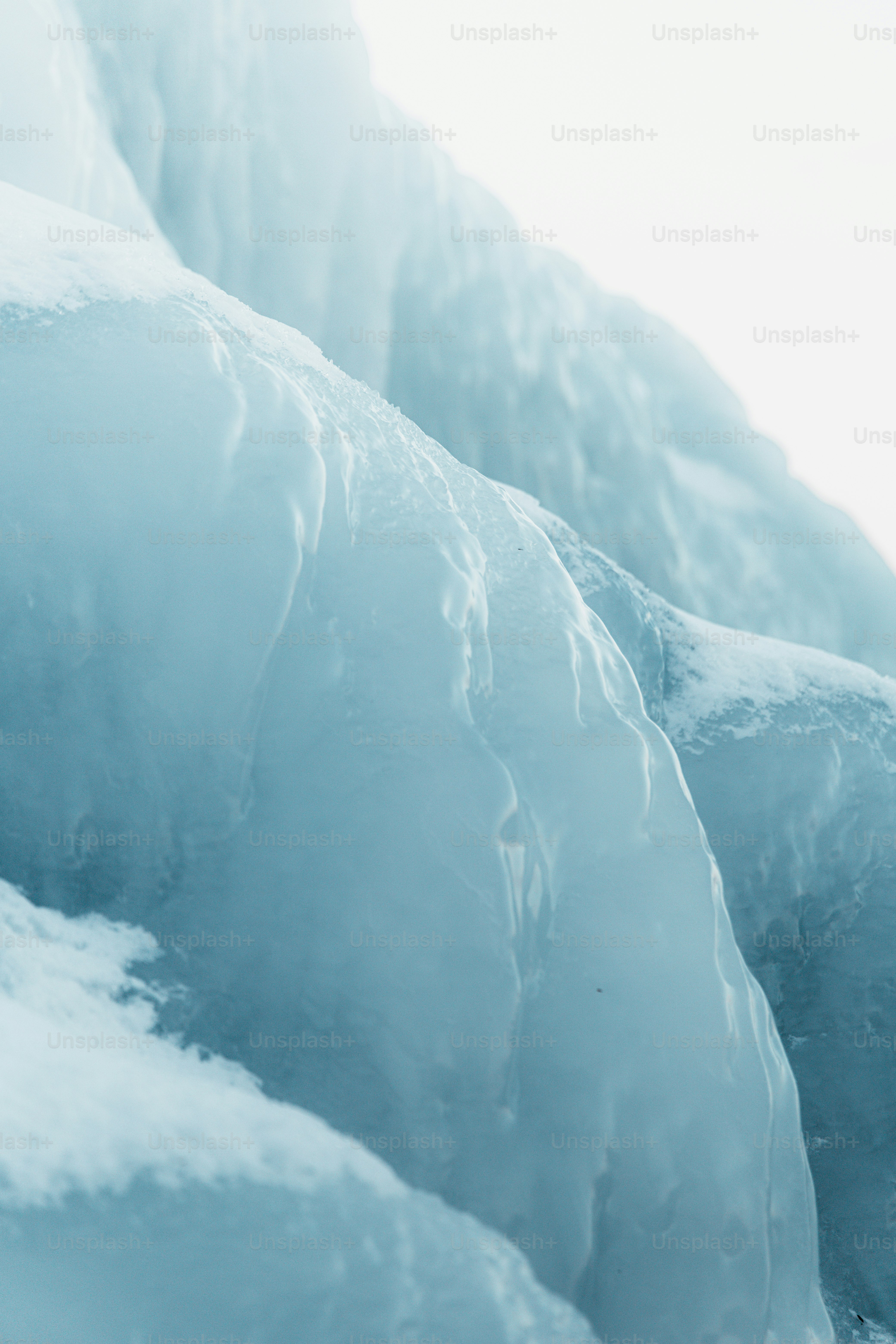 a snowboarder is going down a snowy mountain