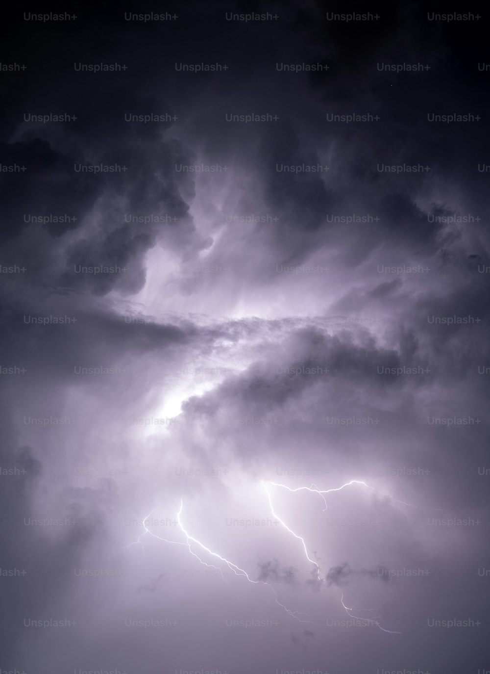 a large cloud with a lightning bolt in the sky