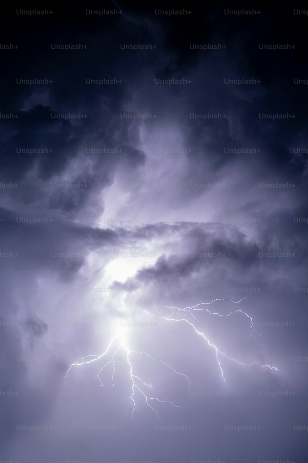 a large cloud with a lightning bolt in the sky