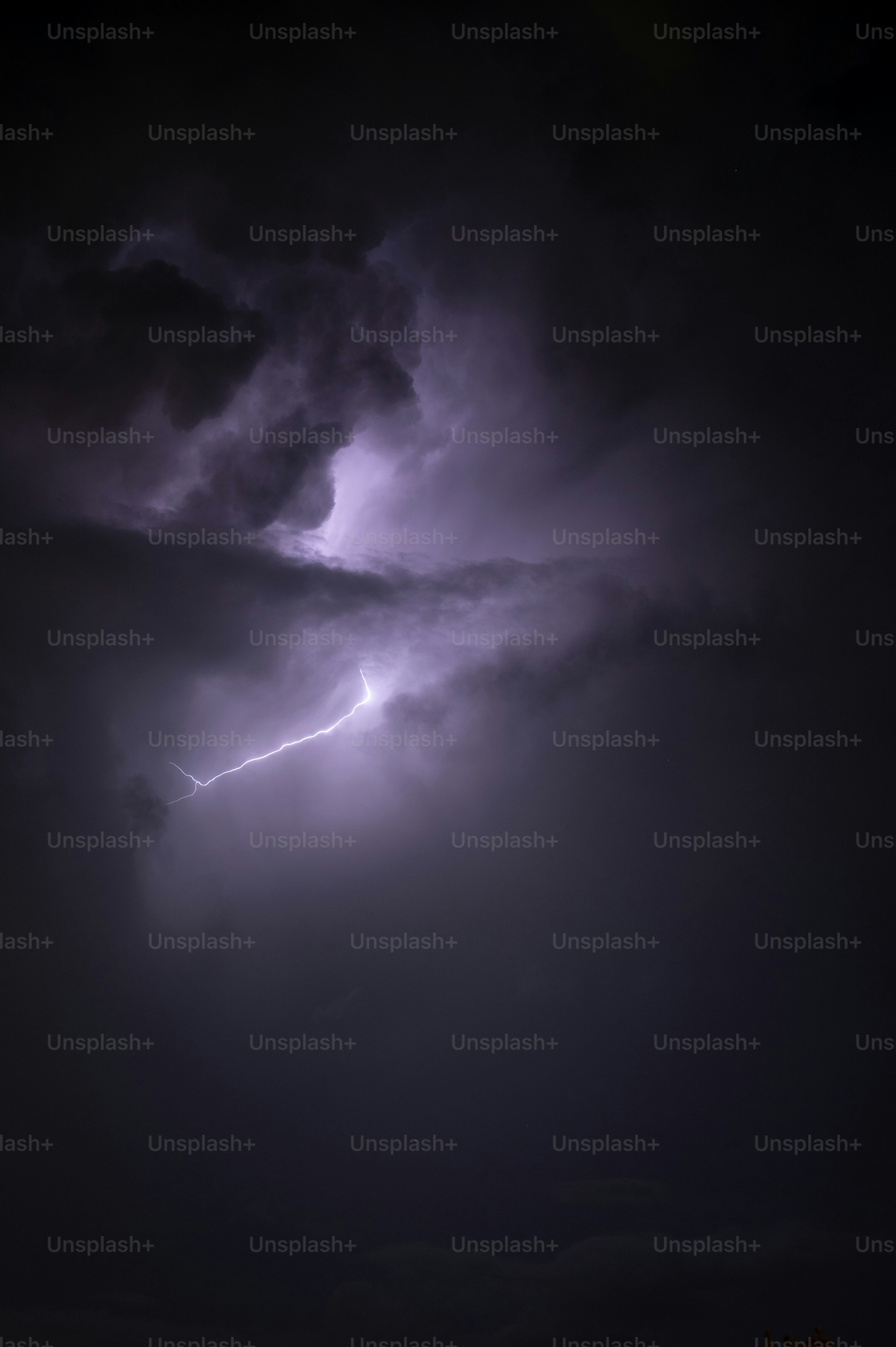 a dark sky with a lightning bolt in the middle of it