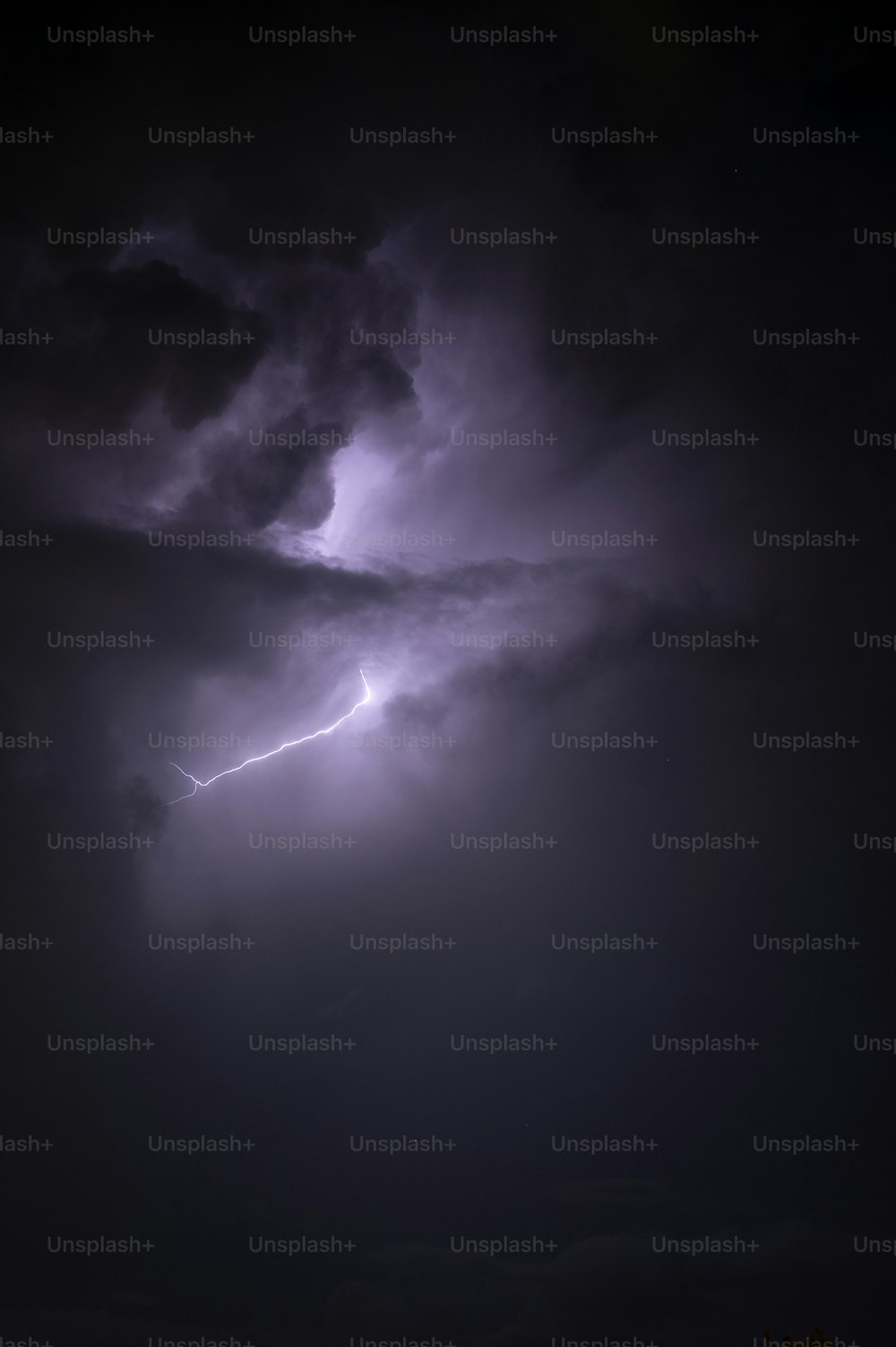 a dark sky with a lightning bolt in the middle of it