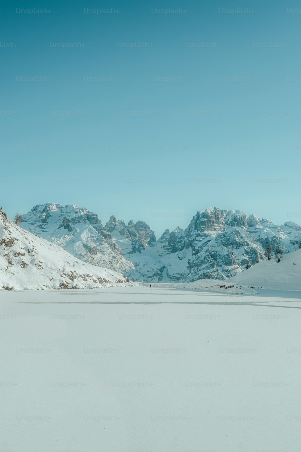 a man riding skis down a snow covered slope