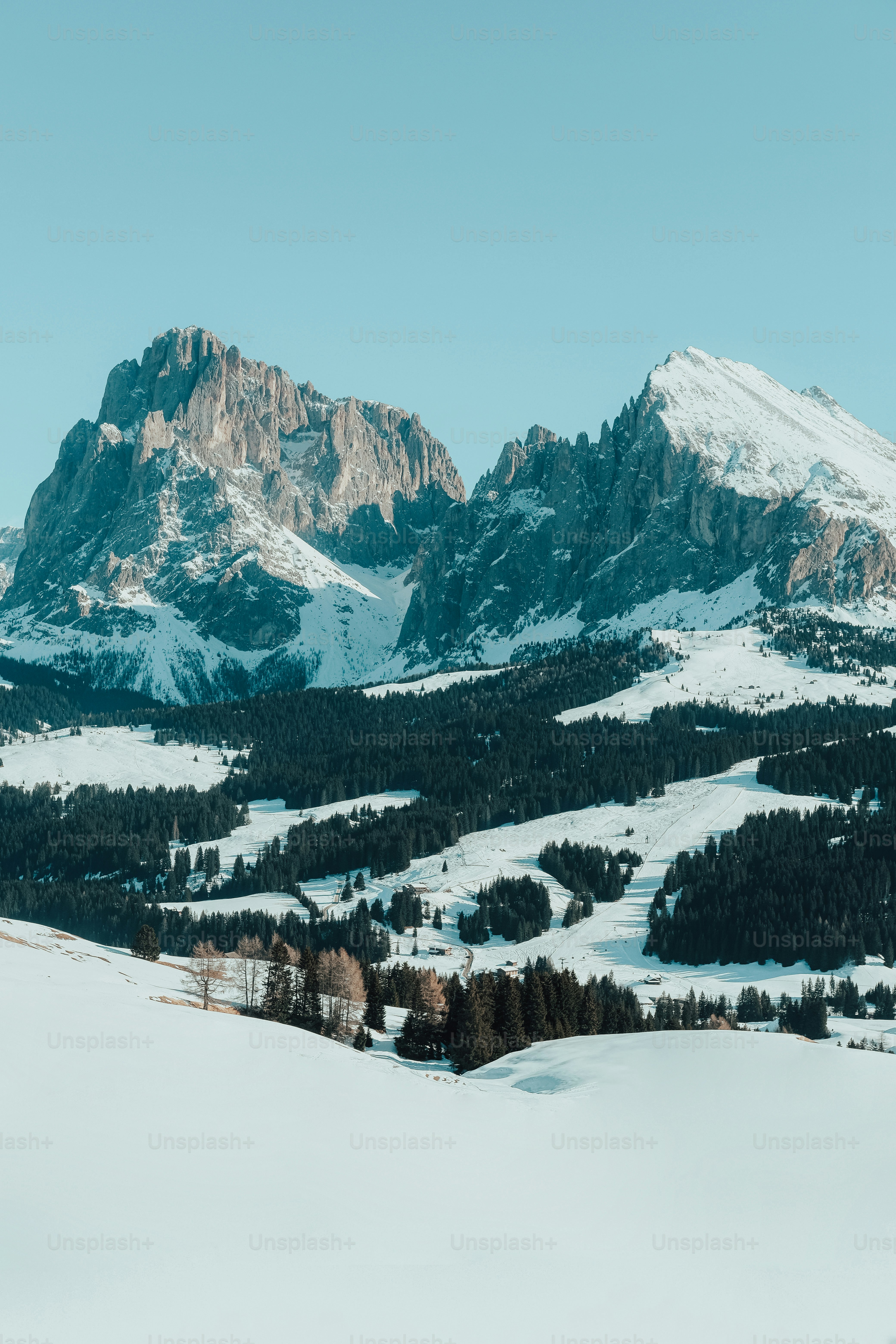 a man riding skis on top of a snow covered slope