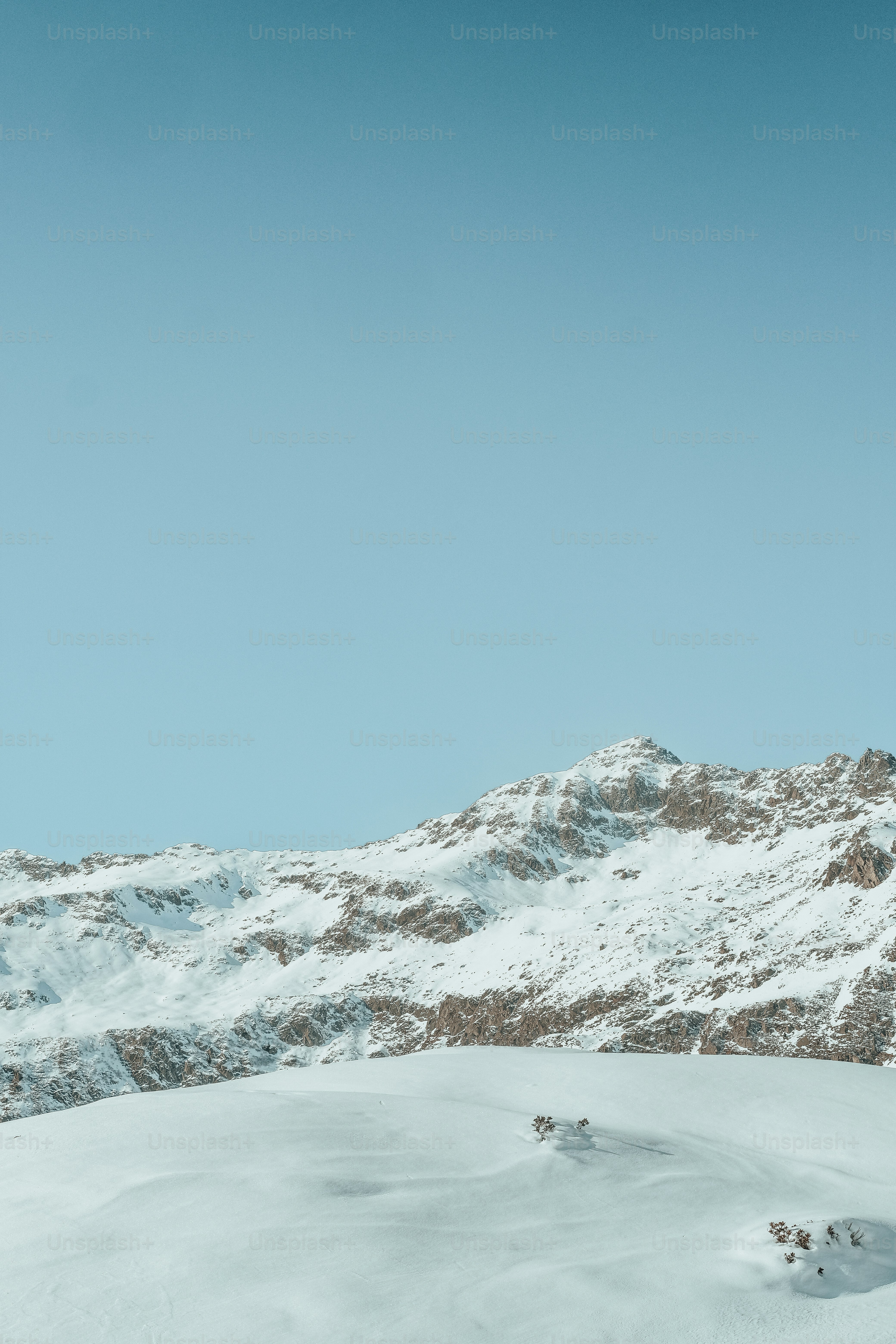 a man riding skis on top of a snow covered slope