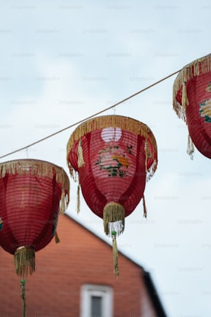 a group of red lanterns hanging from a line