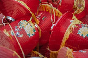 a bunch of red paper lanterns with decorations on them
