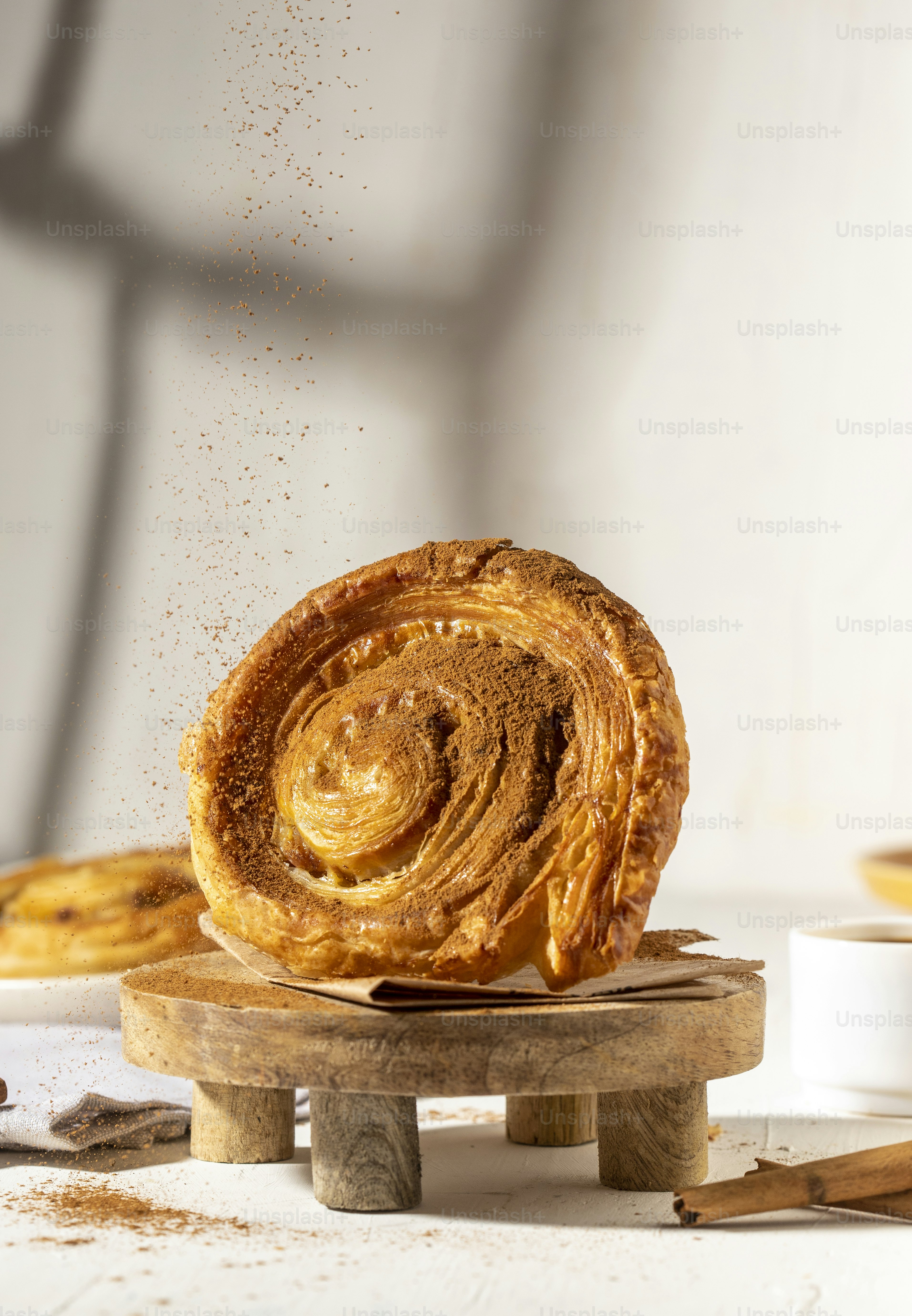 a cinnamon roll sitting on top of a wooden board