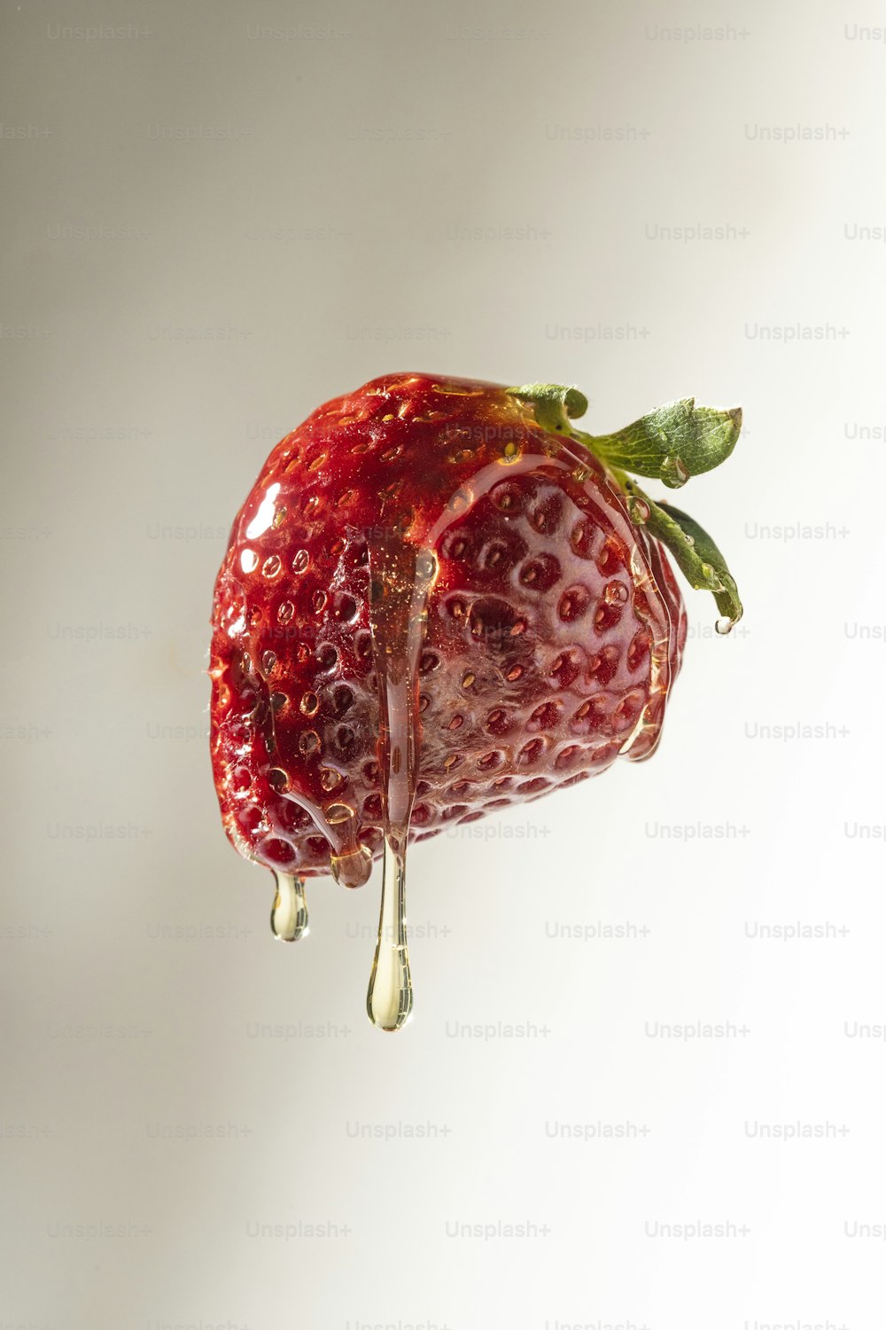 a strawberry with a drop of water on top of it