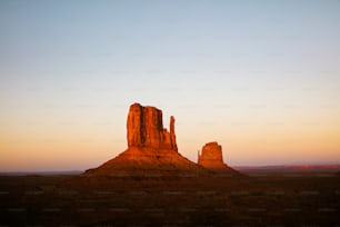 a large rock formation in the middle of a desert