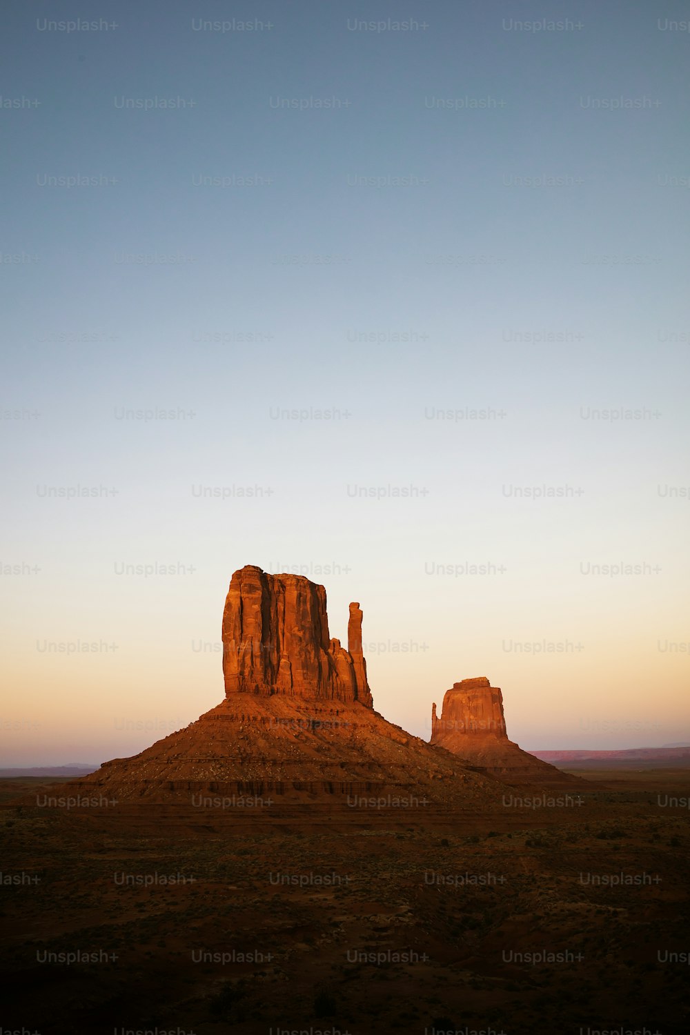 a large rock formation in the middle of a desert