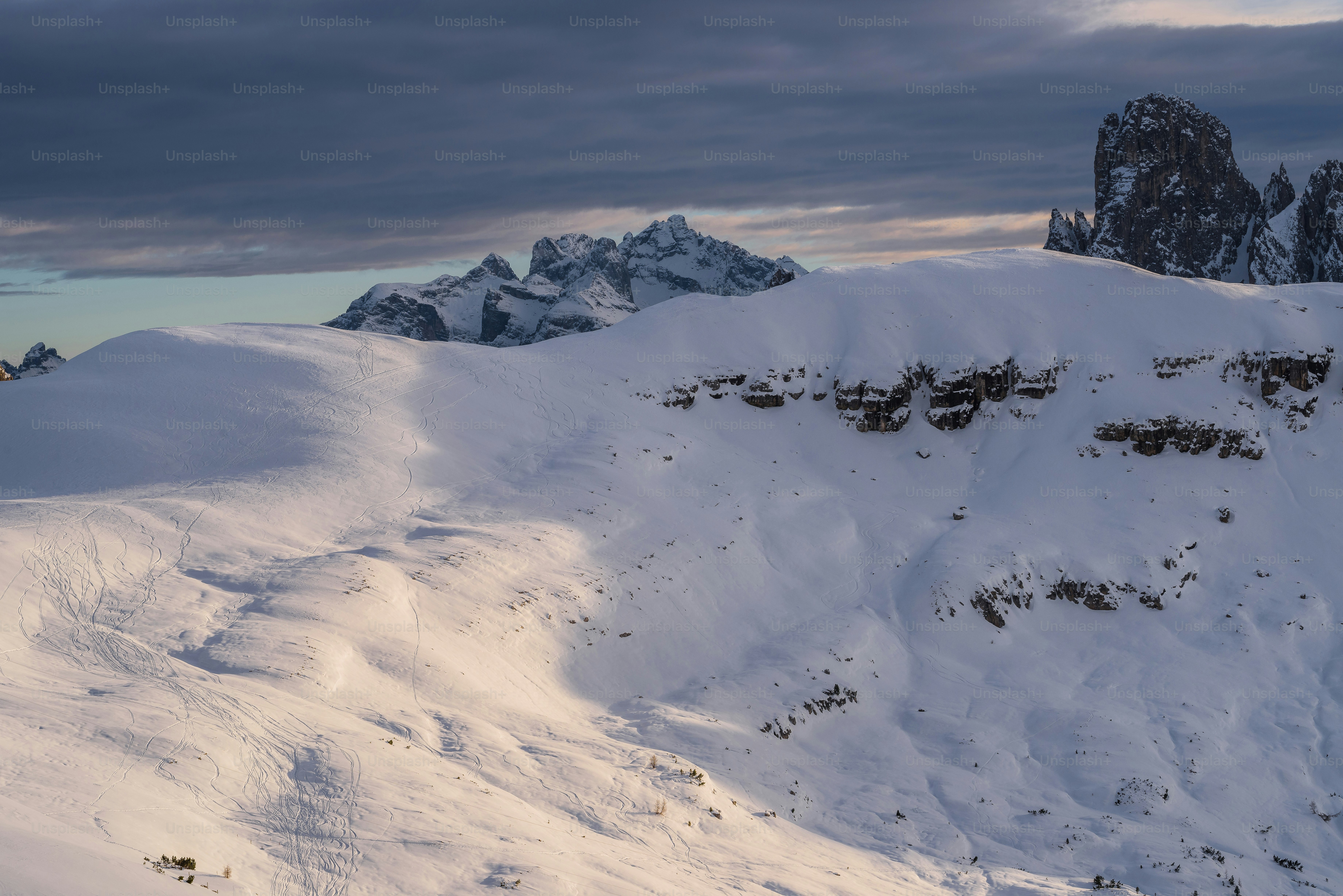a mountain covered in snow with a sky background
