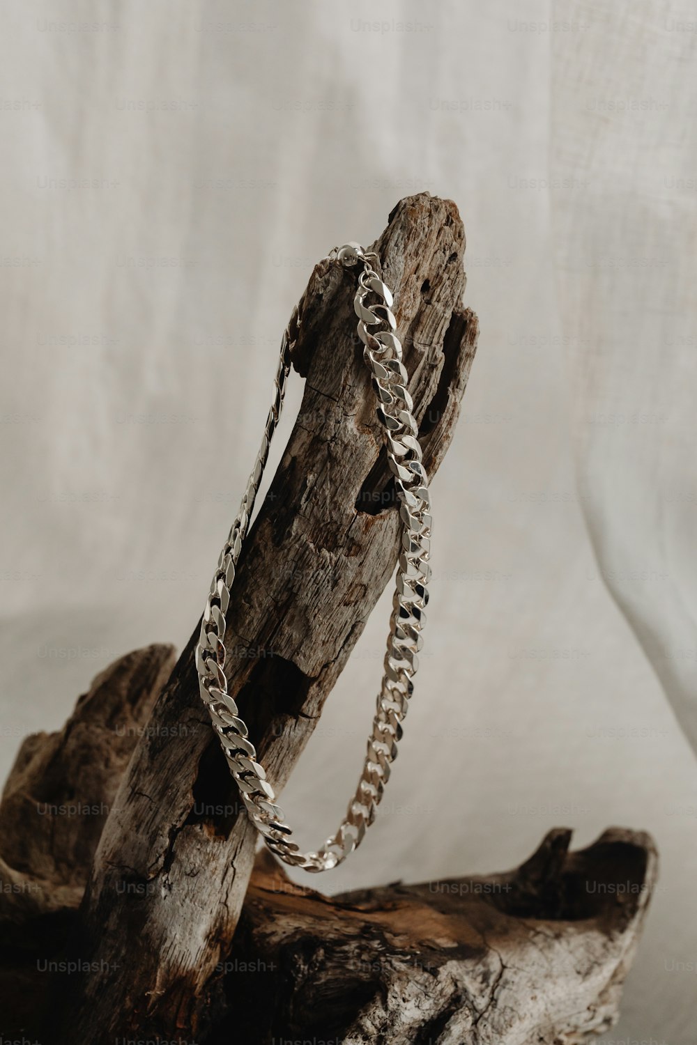 a piece of wood with a chain on it