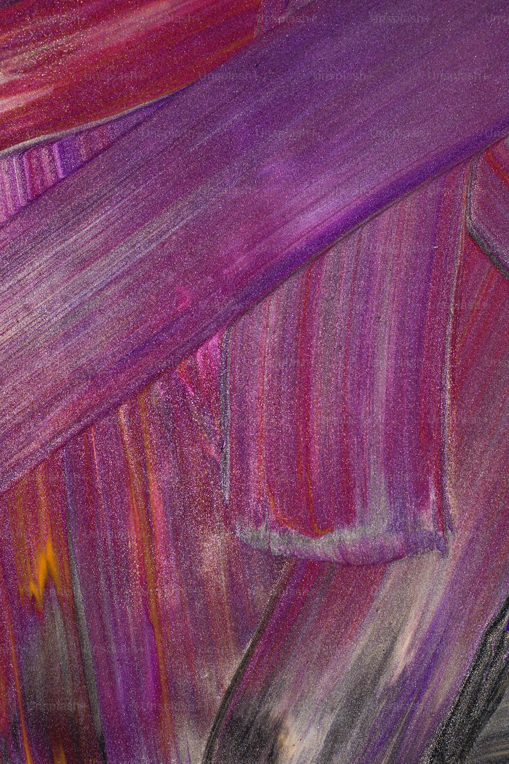 a close up of a painting of purple and red