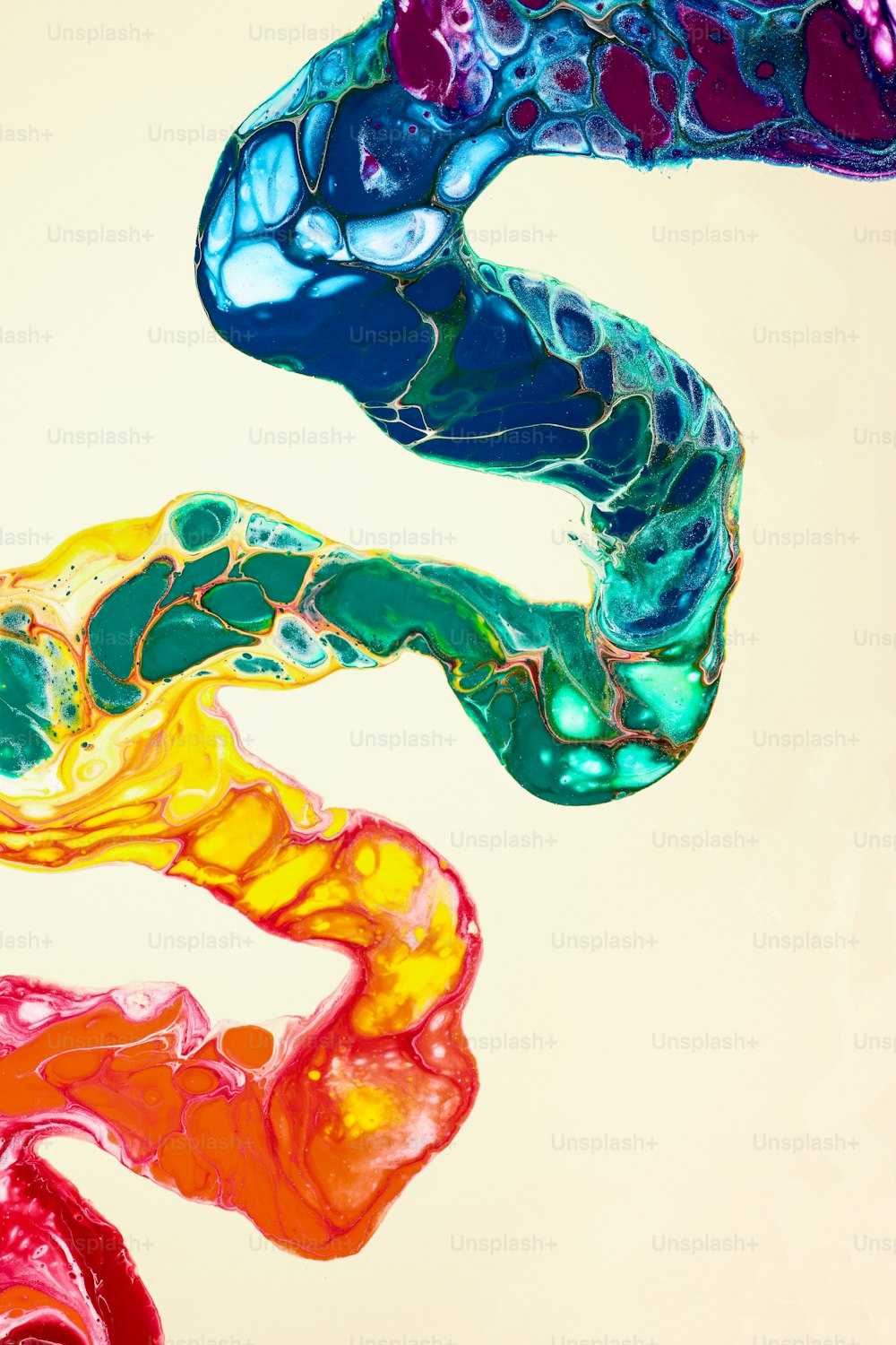 an abstract painting of different colors of liquid