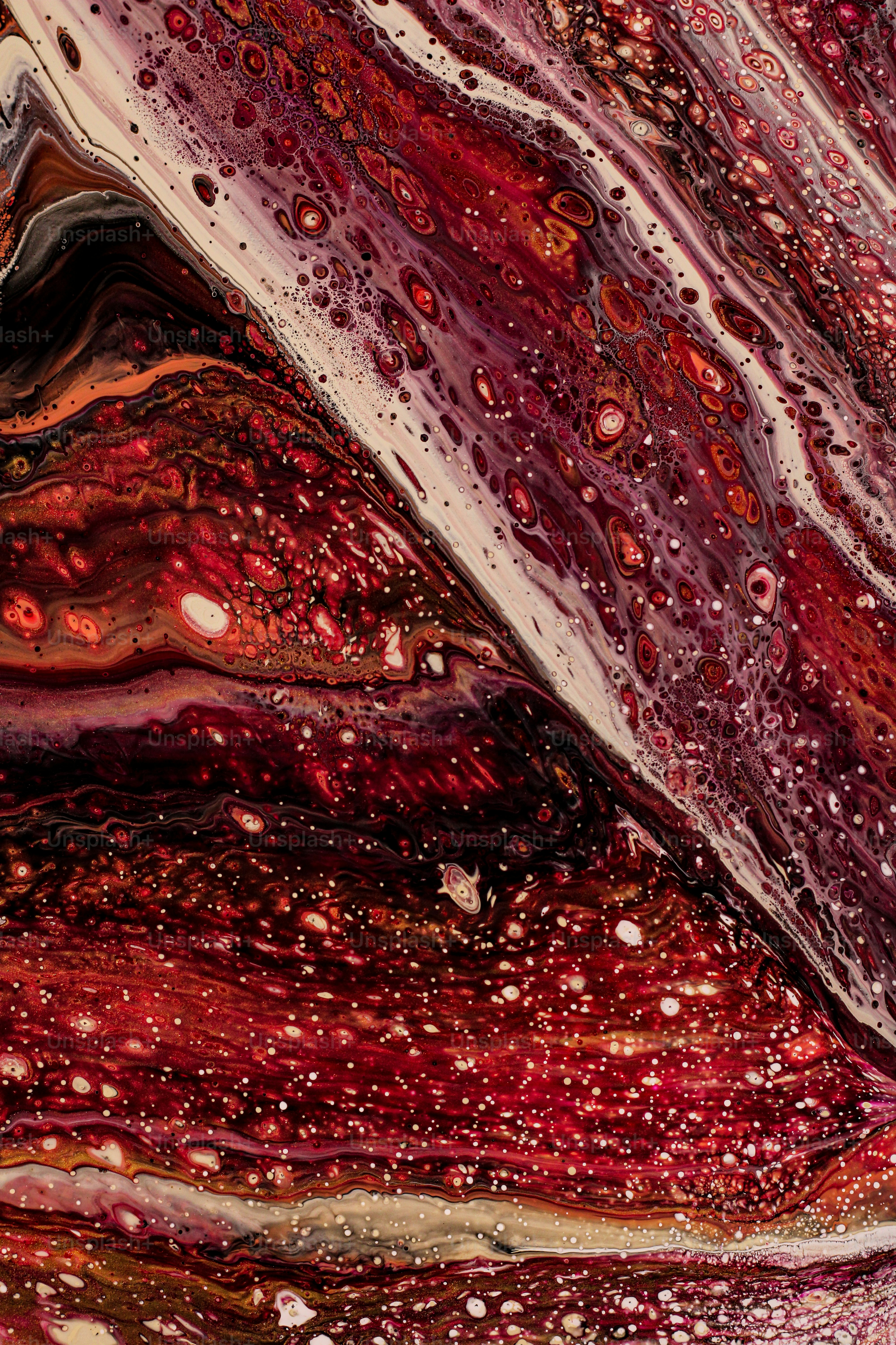 a close up of a red and white abstract painting