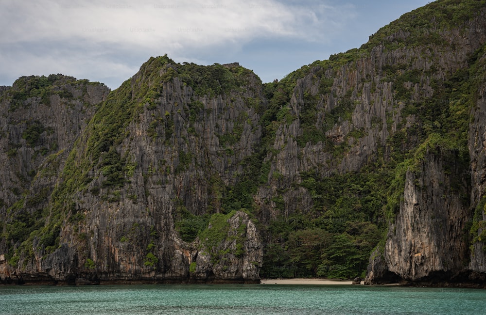 a group of mountains with a body of water in front of them