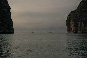 a couple of boats floating on top of a large body of water