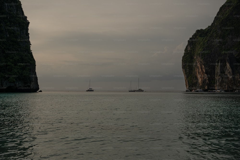 a couple of boats floating on top of a large body of water