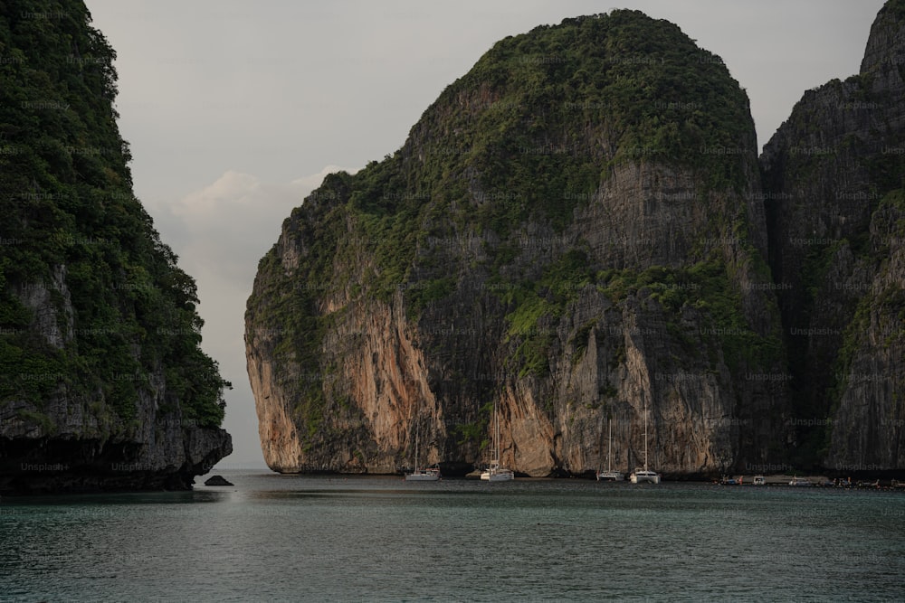 a large rock formation in the middle of a body of water