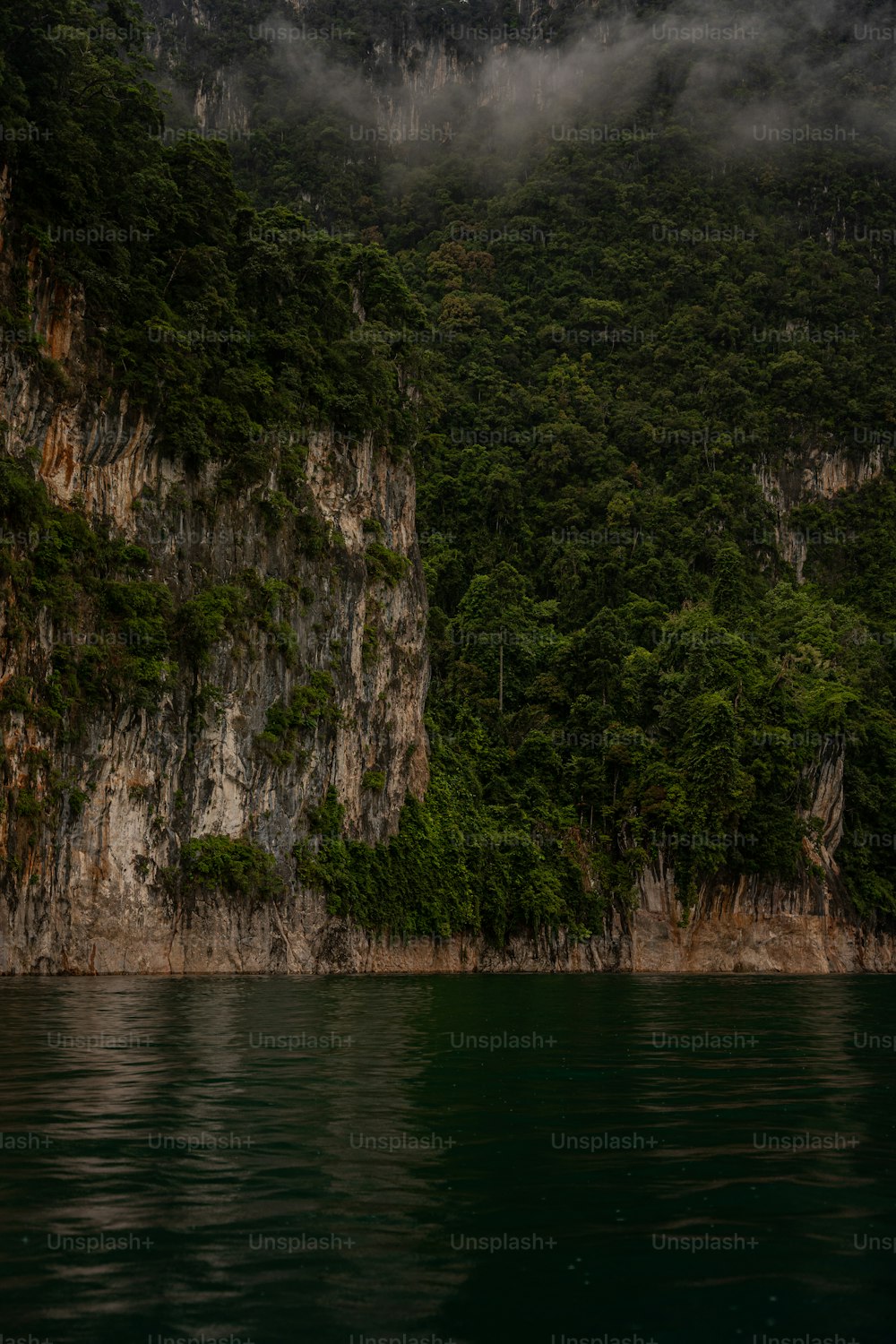 a body of water with a mountain in the background