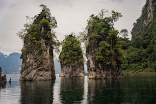 a group of rock formations in the middle of a body of water
