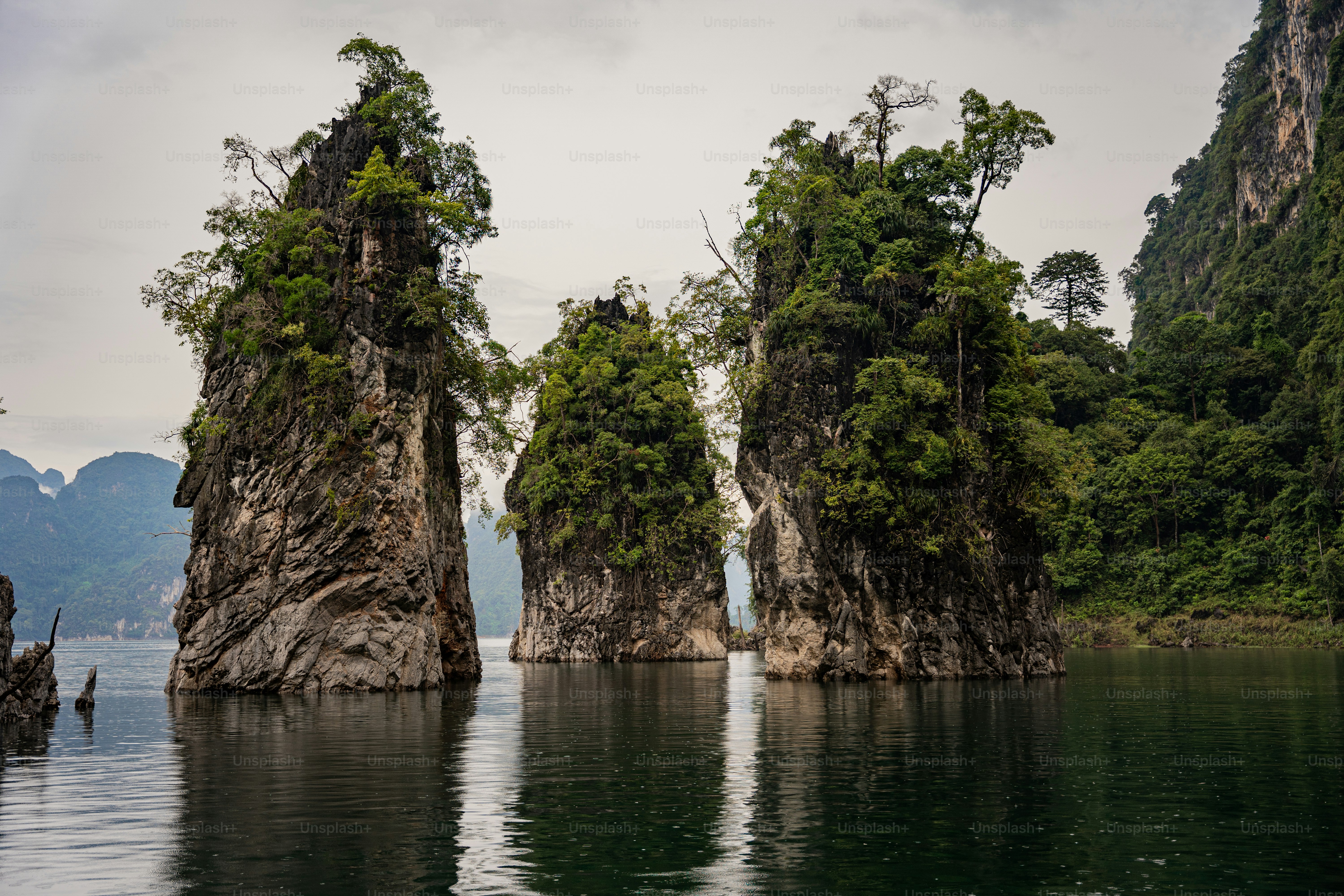 a group of rock formations in the middle of a body of water