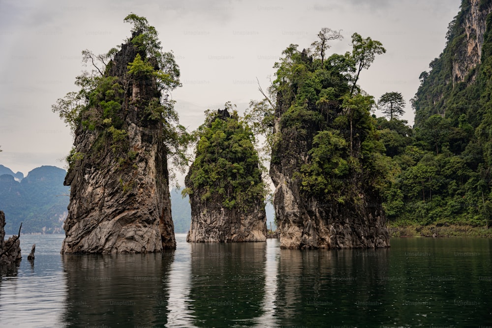 a group of rock formations in the middle of a body of water
