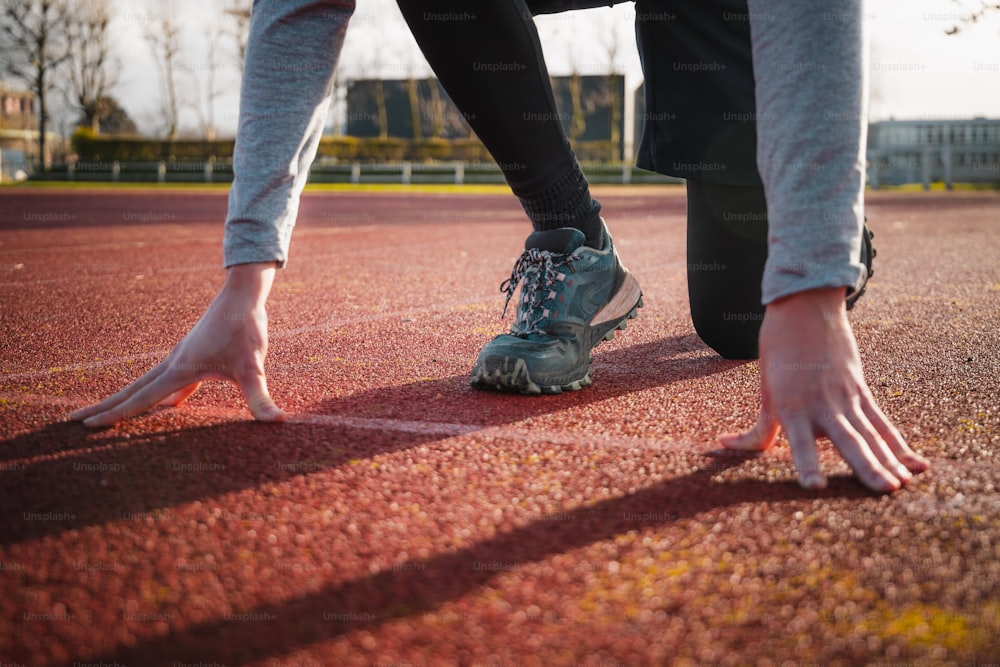 a person standing on a tennis court with their shoes on