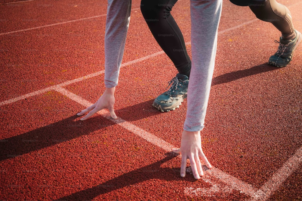 un primer plano de los pies de una persona en una pista de atletismo