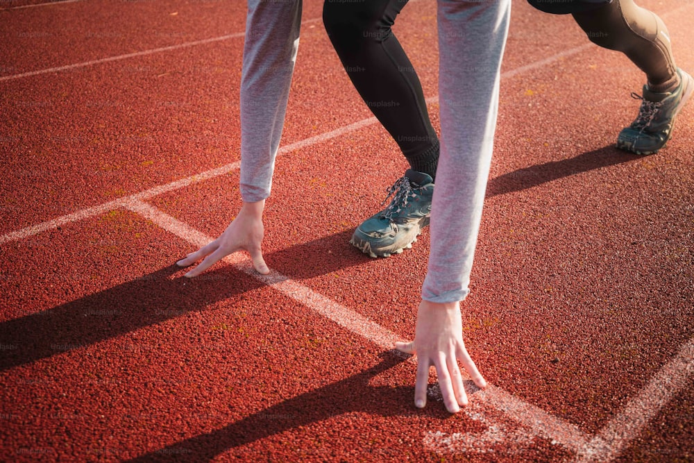 a close up of a person's feet on a running track