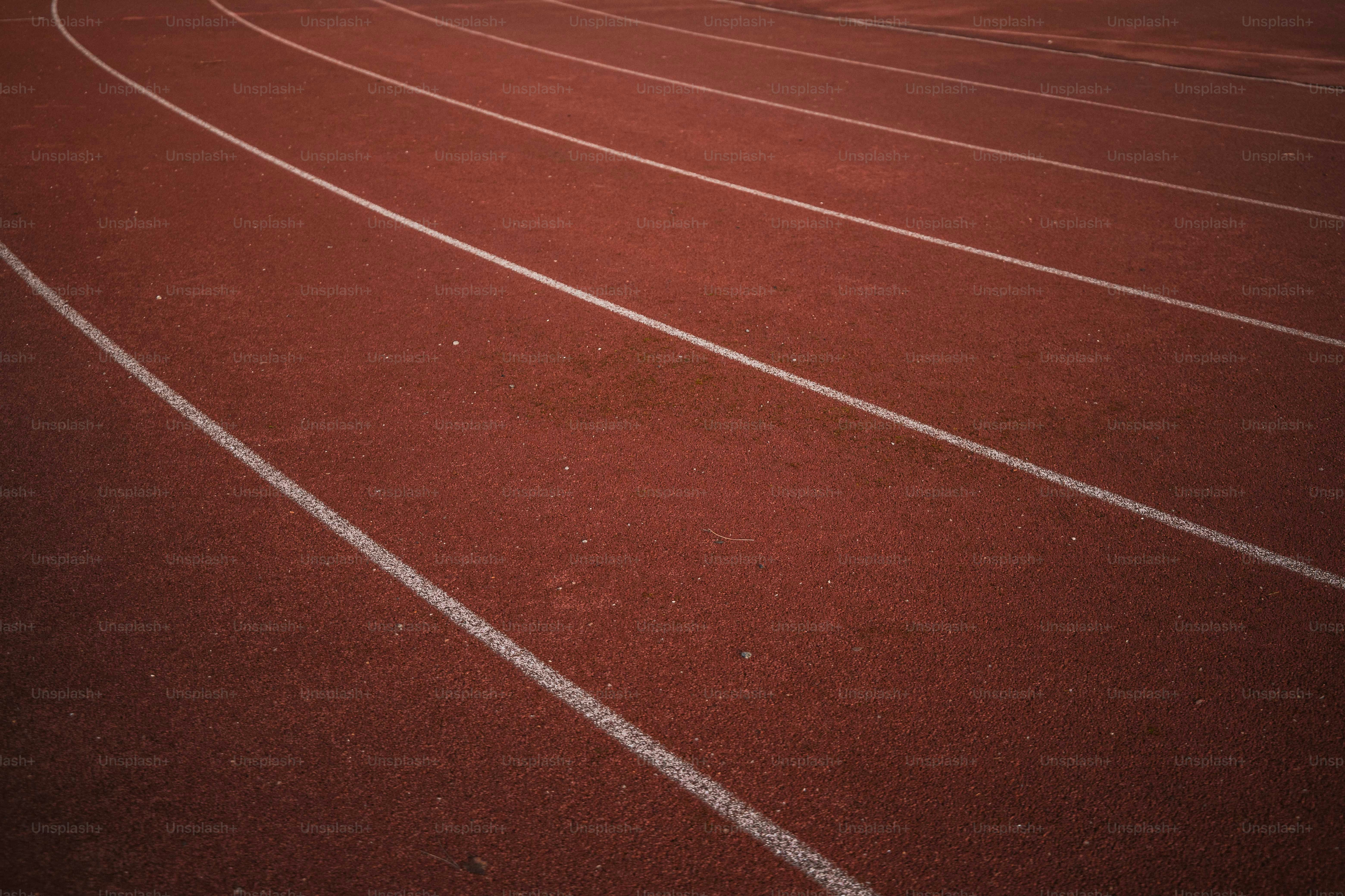 a red running track with white lines on it