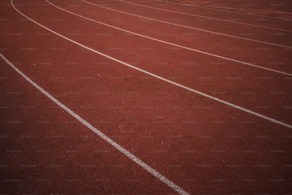 a red running track with white lines on it