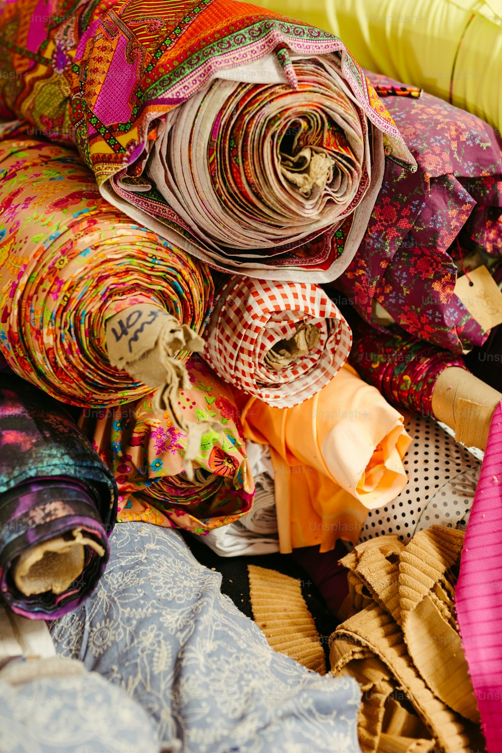 a pile of cloths and scarves are piled on top of each other