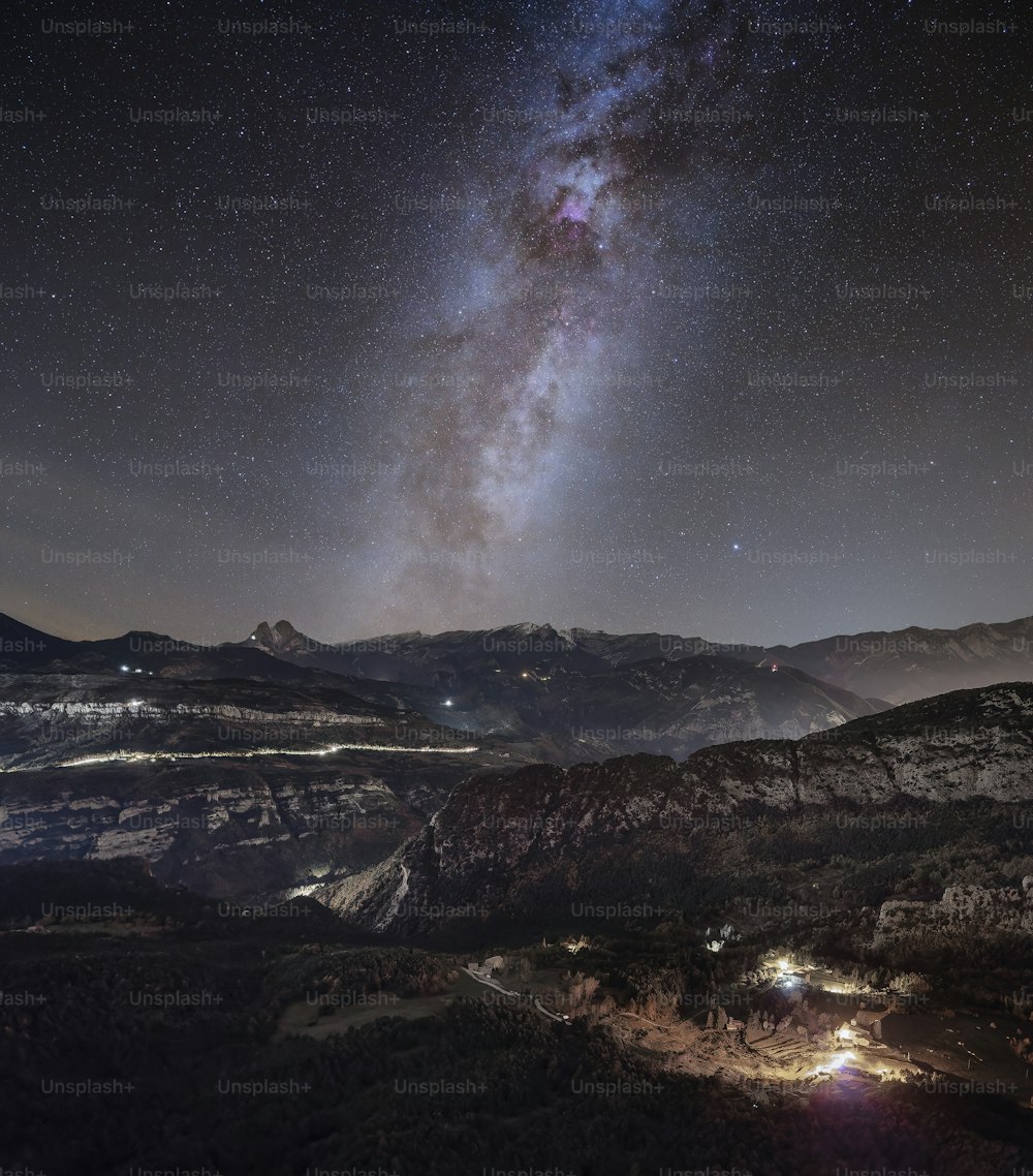 a view of the night sky over a mountain range