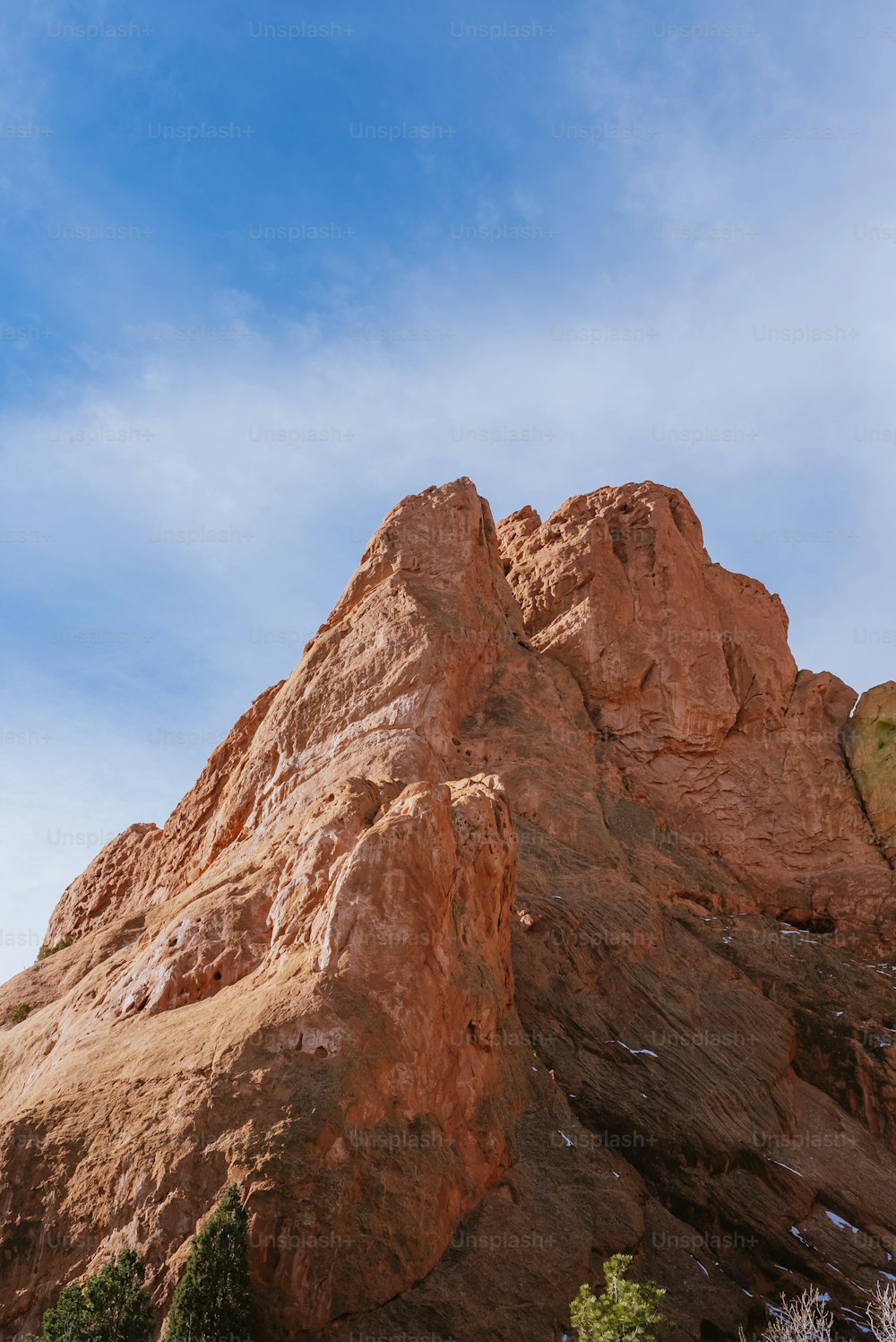 a large rock formation with a blue sky in the background