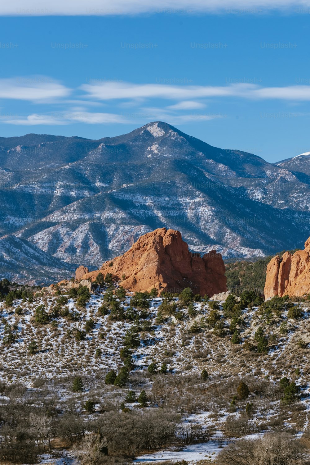 the mountains are covered in snow and trees