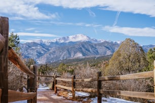 a wooden fence with a mountain view in the background
