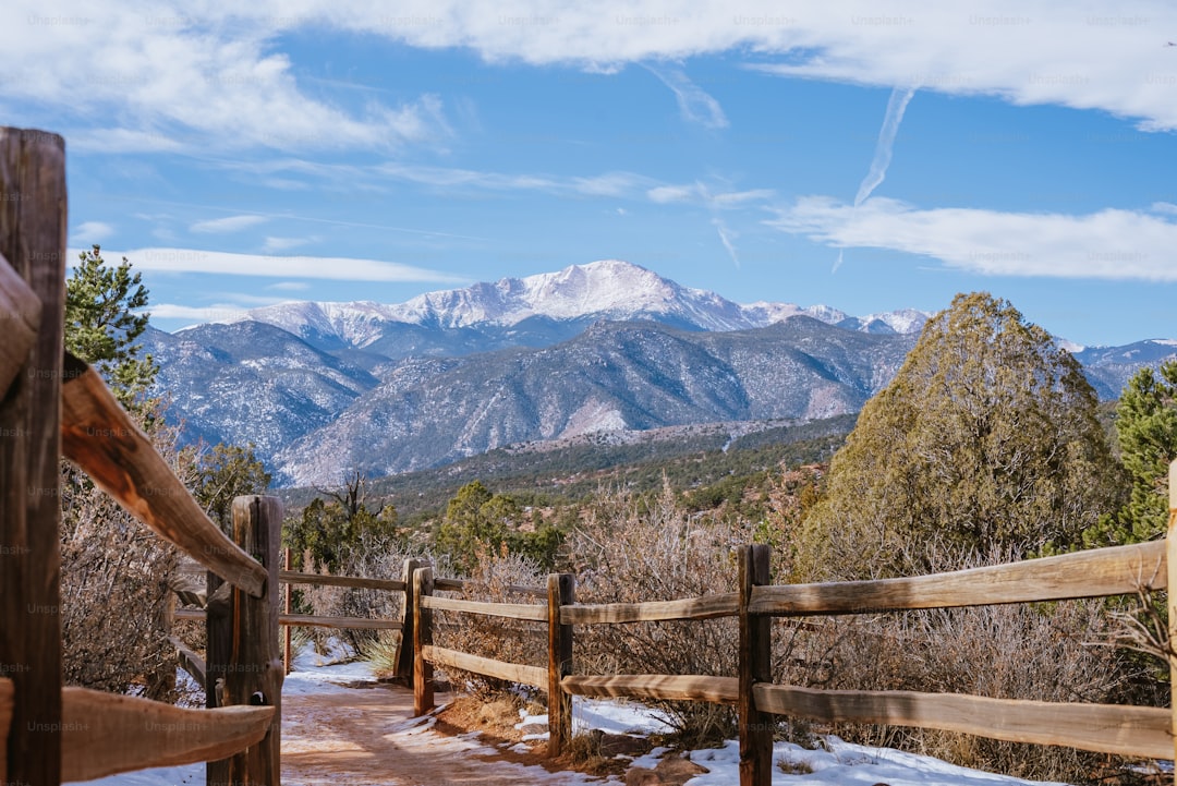 a wooden fence with a mountain view in the background