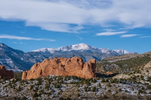 a mountain range with snow capped mountains in the background