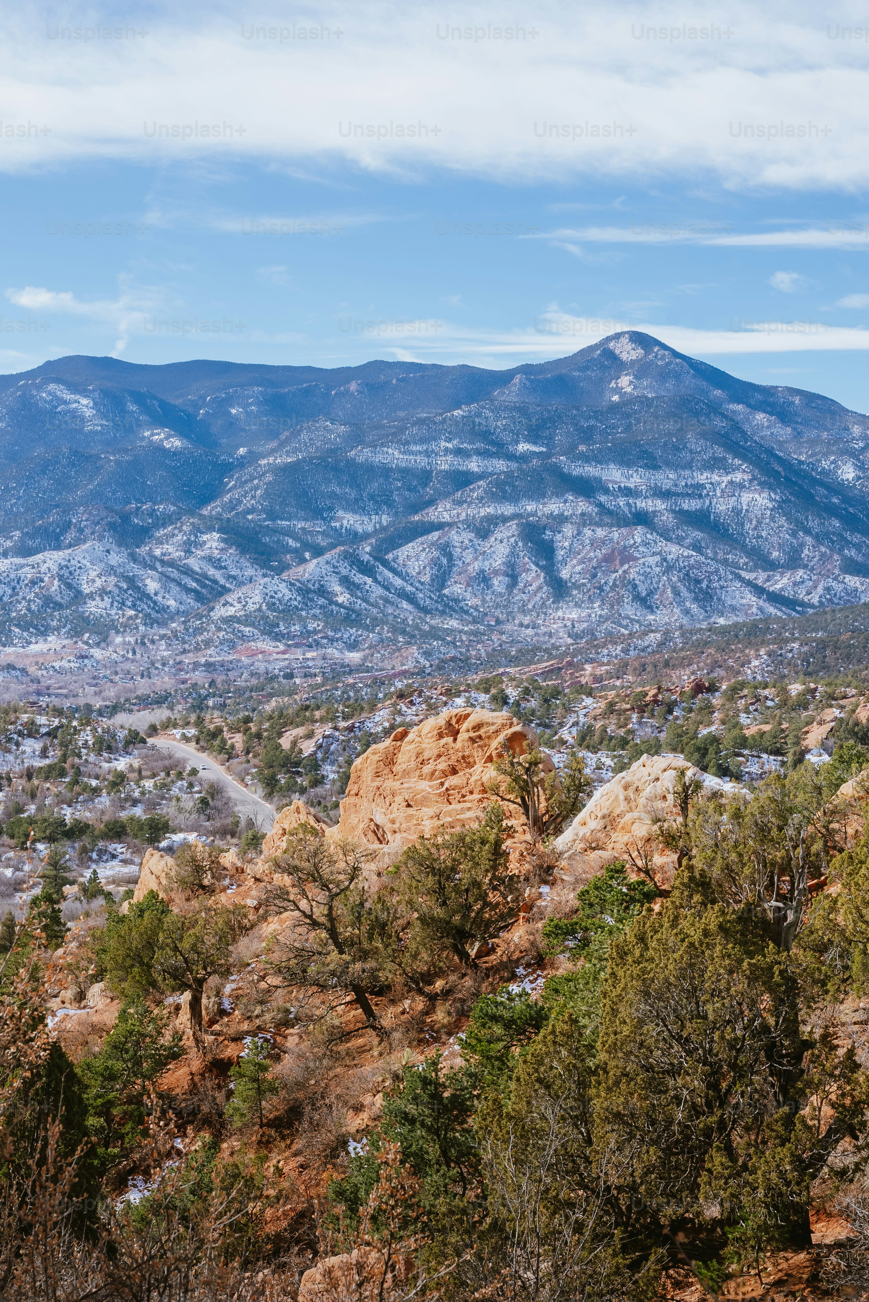 a view of a mountain range with trees in the foreground