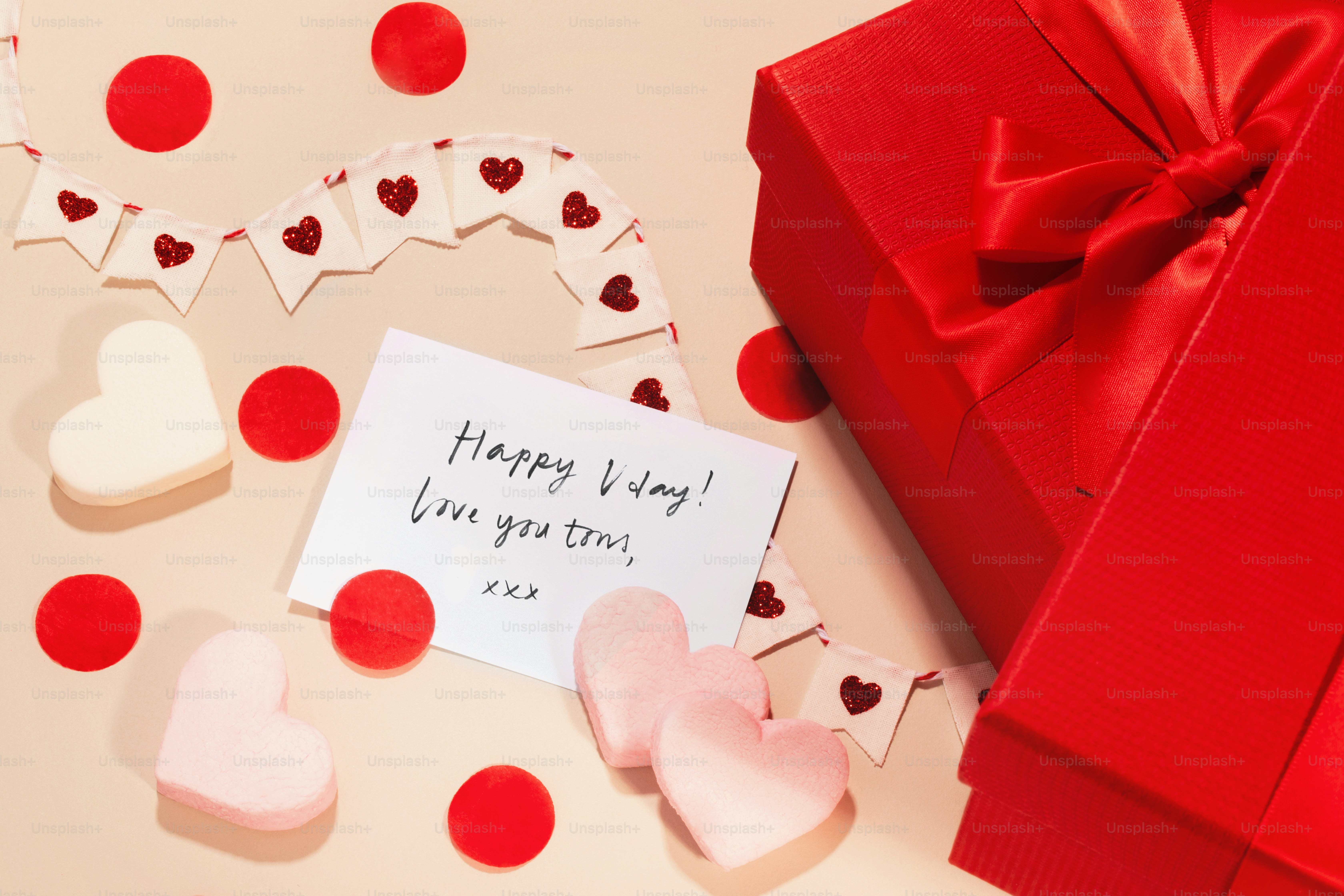 a valentine's day card next to a red gift box