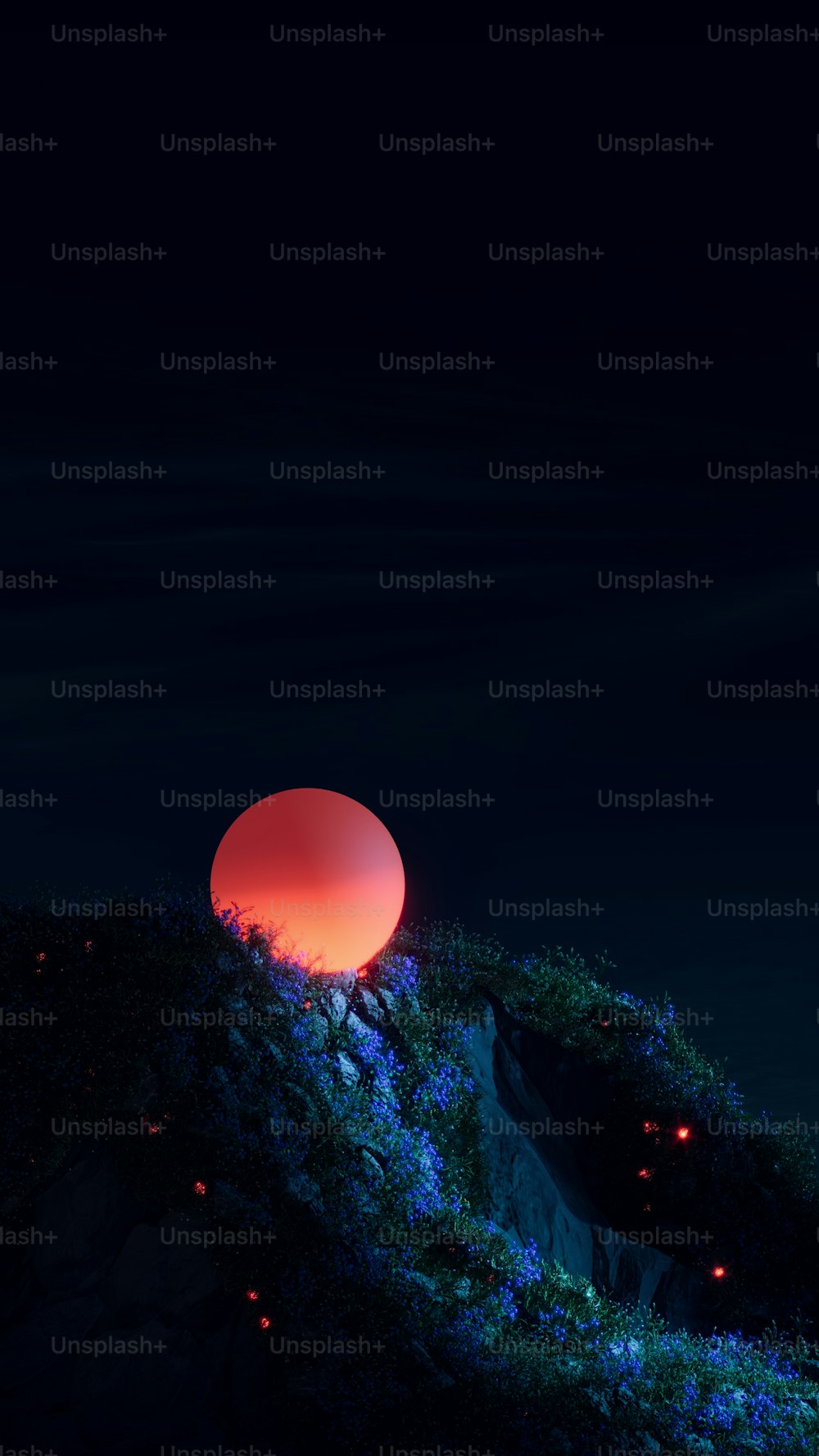 a red ball sitting on top of a lush green hillside