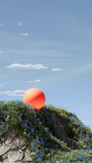 a large orange object sitting on top of a hill