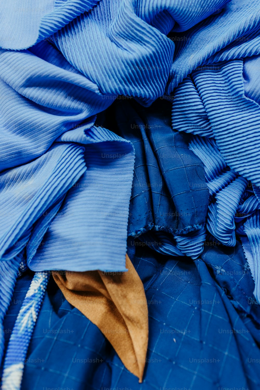 a close up of a blue cloth with a yellow tie