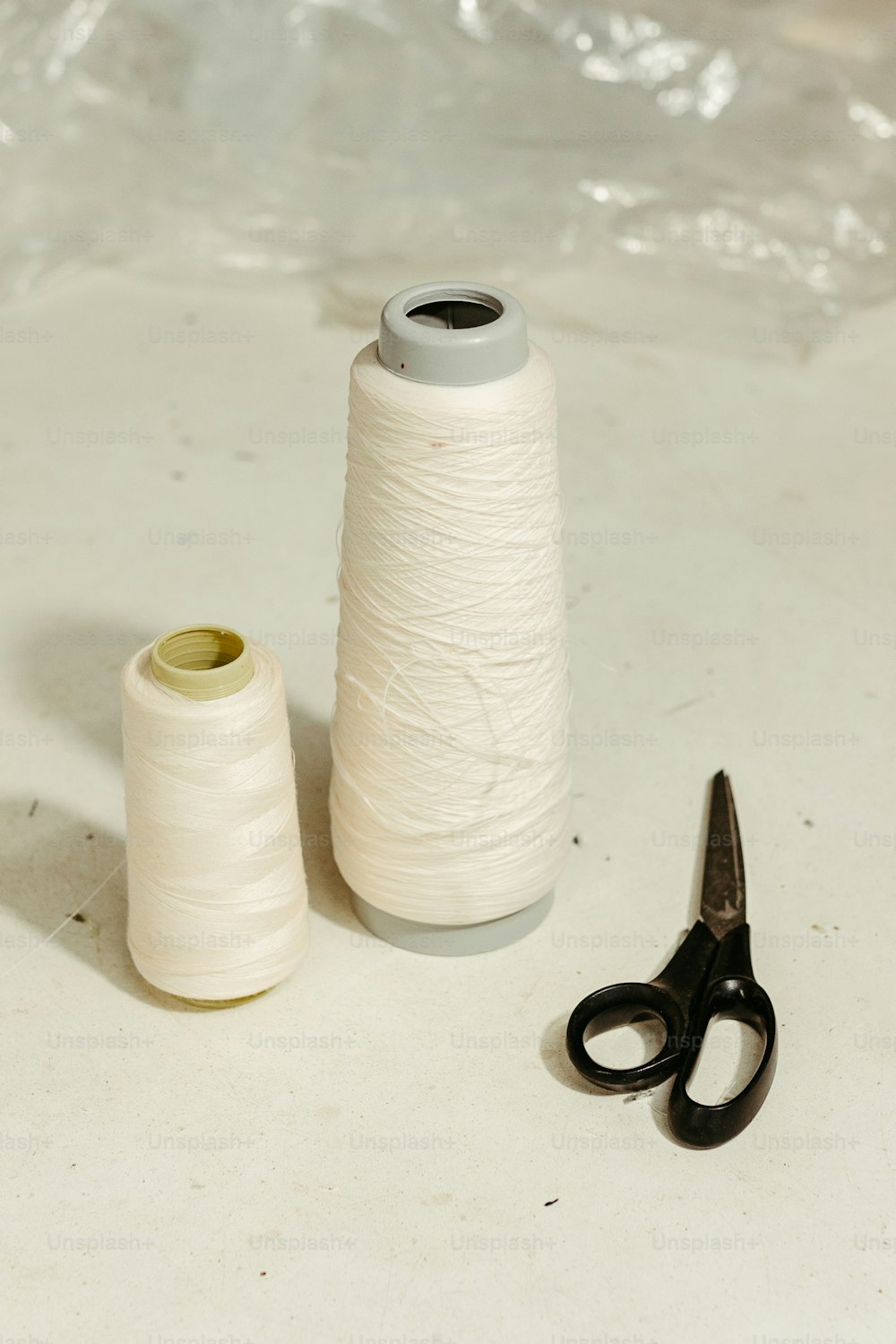 a pair of scissors and a spool of thread