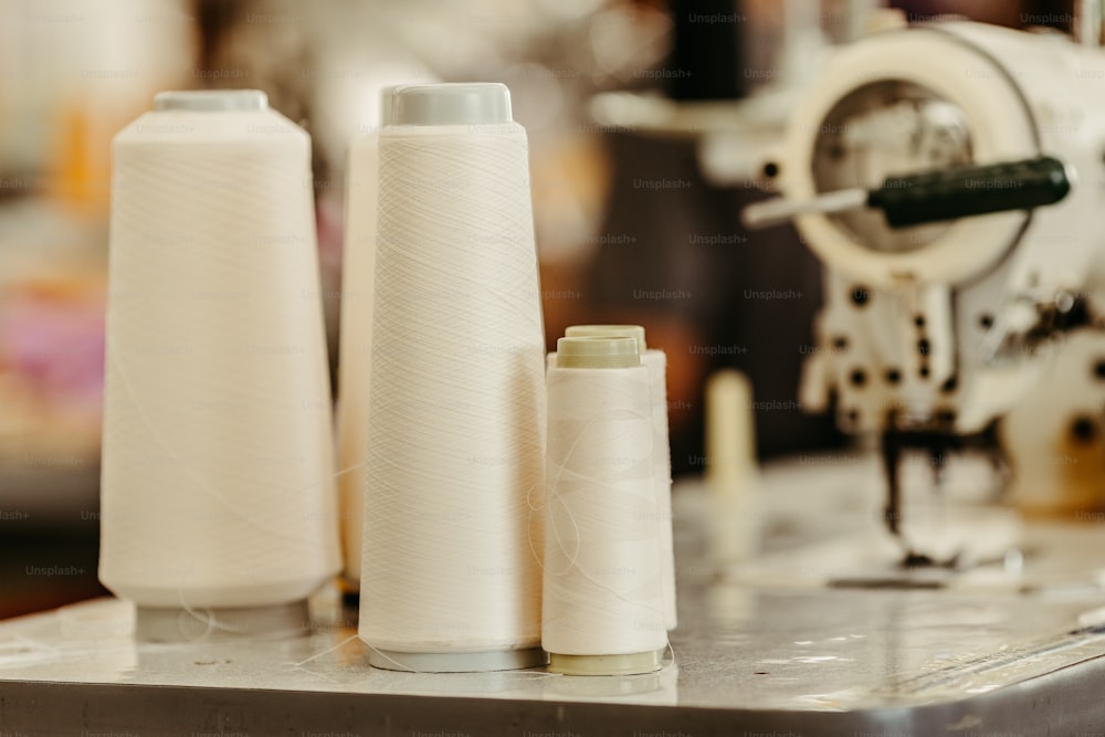 three different types of sewing thread on a machine